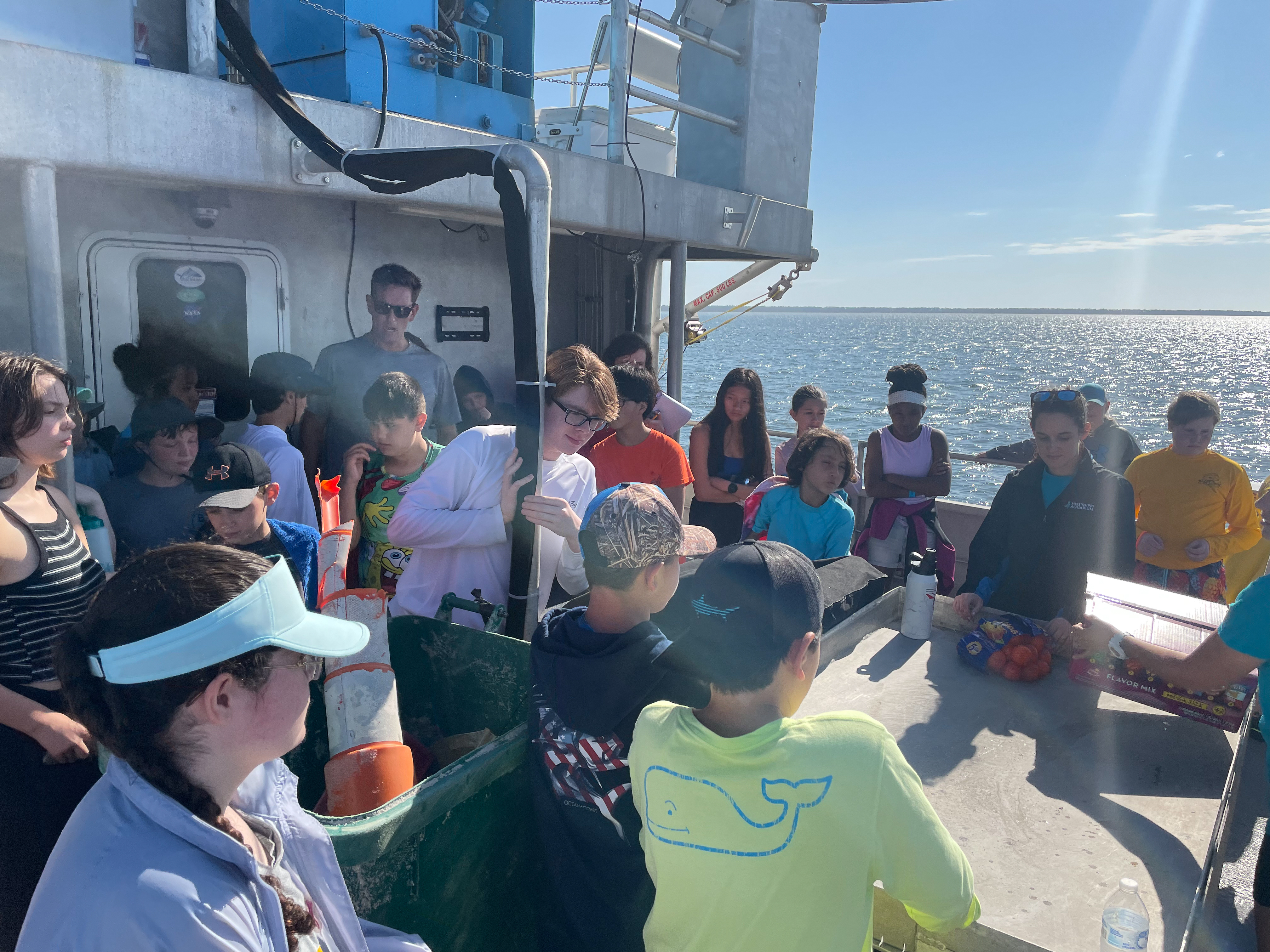 Students gathered around on the boat